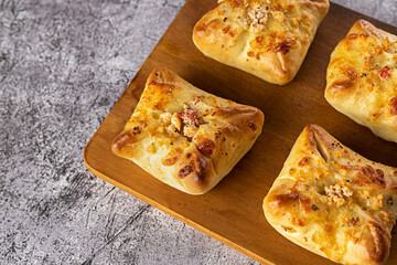 Baked snacks ​​- bread stuffed with cheese and sun-dried tomatoes