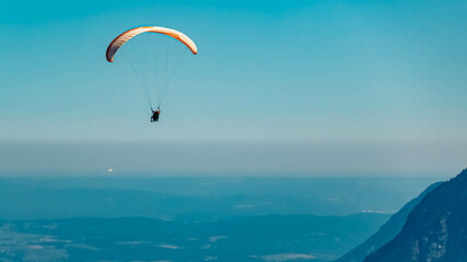 Beautiful alpine summer view with a paraglider at the famous Alpspitze summit near Garmisch Partenkirchen, Bavaria, Germany