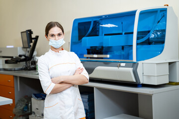 Obraz na płótnie Canvas Pretty scientist in uniform posing for camera. Nurse in mask working in modern laboratory.