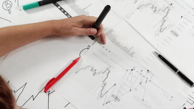 A woman broker at work analyzes the stock market.