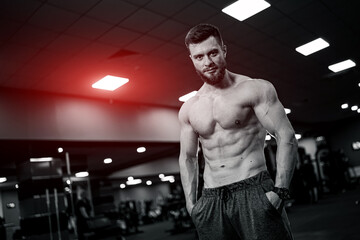 Fototapeta na wymiar Strong athlete male workout in gym. Shirtless muscular man having rest after hard training.