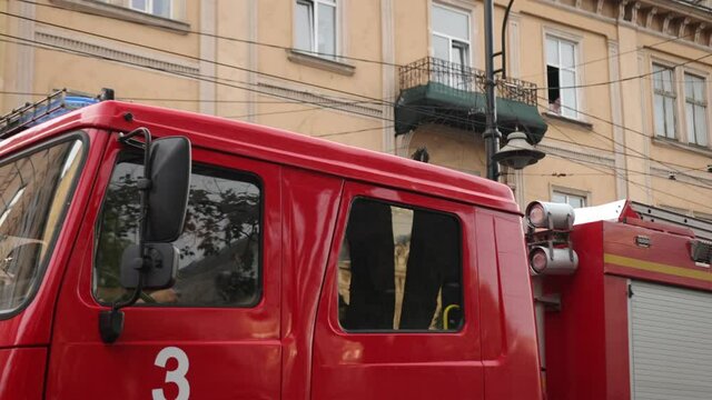 Fire truck pulls up to scene accident at day lights. Firetruck driving on road