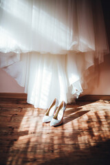 Fototapeta na wymiar white shoes on the background of the wedding dress