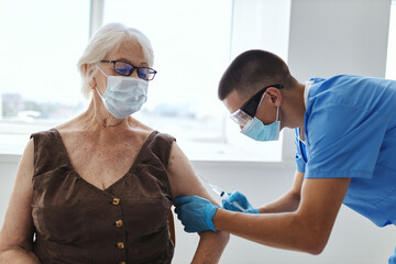 Fototapeta premium doctor giving an injection to a patient vaccine health passport immunity protection