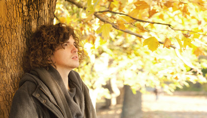 Young upset man profile portrait standing near the tree © LP Design