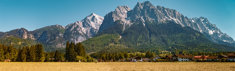 Fototapeta na wymiar High resolution stitched panorama of a beautiful alpine summer view with the famous Zugspitze summit in the background at Grainau near Garmisch Partenkirchen, Bavaria, Germany