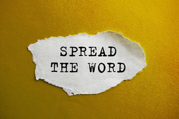 The inscription SPREAD THE WORD on torn paper. Marketing conceptual word on yellow background.