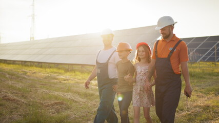 Two parents brought their children to work. Two employees of a solar power plant tell children...