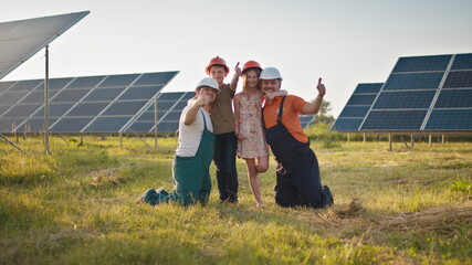 Two employees of the solar power plant brought their children to work and put a protective helmet...