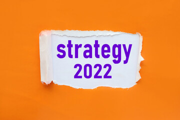 STRATEGY 2022. text on torn paper. test in black letters