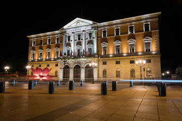 Fototapeta premium Night view of the City Hall building (Hotel de Ville d'Annecy) illuminated from the Hotel de Ville Square, Annecy, France
