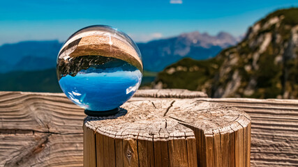 Crystal ball alpine landscape shot at the famous Steinplatte summit near Waidring, Tyrol, Austria