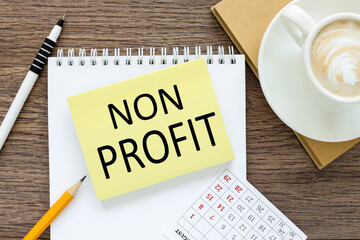 Non Profit. text on sticker on white paper near white cup of coffee