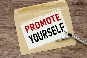 Promote Yourself. text on paper on craft envelope