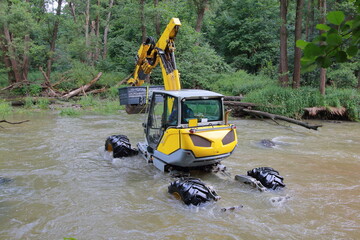 walking dredger working in the river - river bed restoration