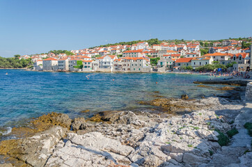 Picturesque bay and the old town of Postira. Postira lies on the northern coast of Brac island in Croatia. - obrazy, fototapety, plakaty