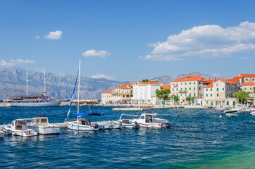 Fototapeta na wymiar Picturesque bay and the old town of Postira. Postira lies on the northern coast of Brac island in Croatia.