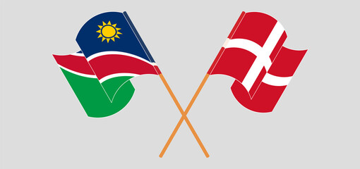 Crossed and waving flags of Namibia and Denmark