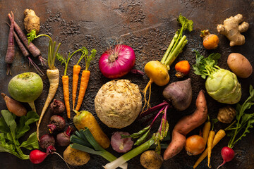 Assortment of Vegetables and root vegetables on textured background. Autumn harvest. Healthy food...