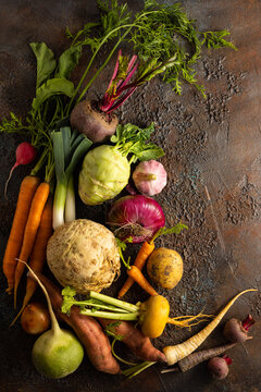 Assortment of Vegetables and root vegetables on textured background. Autumn harvest. Healthy food and vegetarian concept.