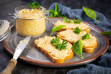 Delicious toasts with homemade chicken rillettes. Sandwich snack  with chicken pate on wooden...