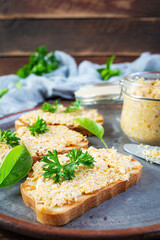 Delicious toasts with homemade chicken rillettes. Sandwich snack  with chicken pate on wooden background