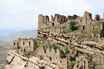 ruined stone houses on the slopes of caucasus mountains in abandoned ancient village old Kahib in Dagestan
