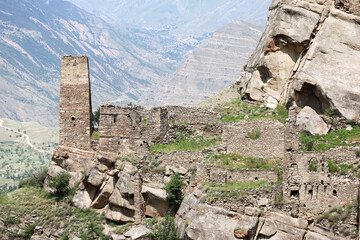 ancient stone battle tower in abandoned village old Kahib in Dagestan with scenery mountain valley background