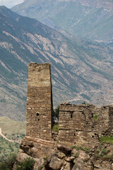 ancient stone battle tower in abandoned village old Kahib in Dagestan with scenery mountain valley background