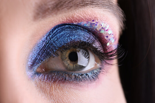 Female eye with bright evening makeup closeup