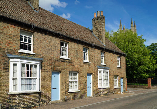 Row of Victorian Cottages with Tree and Church Tower