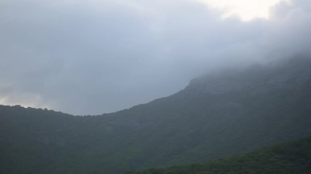 Close up shot of top of Girnar mountain covered with beautiful clouds during monsoon season. At Junagadh, Gujarat, India