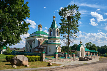 Old antique temple of Saints Unmercenaries and Wonderworkers Cosma and Damian in Vishnevo at summer, Minsk region, Belarus.