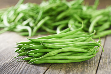 fresh green beans on a wooden table, selective focus.