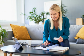 Successful young woman calculating home finances planning savings