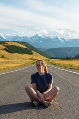 Naklejka na ściany i meble Woman om the Chuysky trakt road in the Altai mountains.