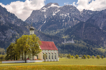 St. Colomans Church. In the background is the Neuschwanstein castle. Schwangau, Germany.
