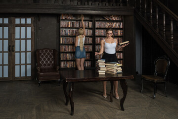 Two young librarians in the classical library room.