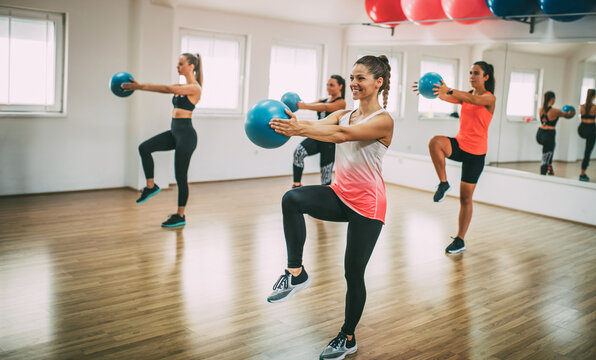 A group of women are working out in a fitness center.