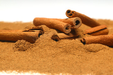 Cinnamon sticks and cinnamon powder isolated on white background, healthy spice, (Cinnamomum)