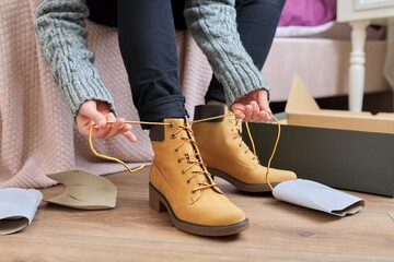 Autumn winter season, new shoes, close-up woman shoeing warm boots