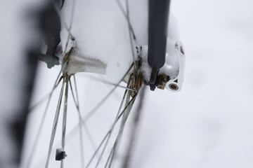 Bicycle wheel completely covered with snow closeup
