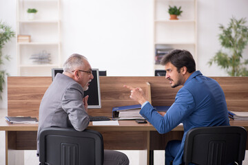 Two male employees working in the office