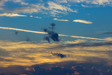 Dramatic soft sunrise, beautiful pink violet orange clouds against blue sky
