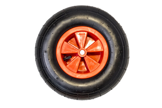 new nylon rubber inflatable black round wheel with red disc from garden wheelbarrow close up isolated on white background