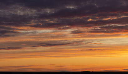 Naklejka na ściany i meble The evening sunset. Panorama. Majestic Storm Clouds. Tragic gloomy sky.