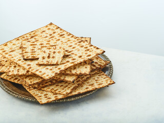The symbol of the Jewish Passover is the sacred bread matzah. Close-up. Careful viewing. Religion, traditions, prayers. Restaurant, hotel, advertisement, banner, poster.