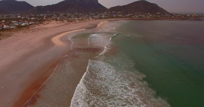 Aerial over Beach Waves and City, Pringle Bay, South Africa