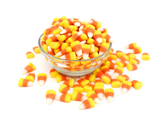 Candy corn in jar on white background
