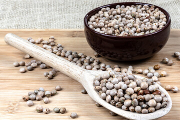 pigeon pea or tuvar beans or guandu bean (Cajanus cajan) seeds in ceramic bowl and spoon on the wooden table in Brazil